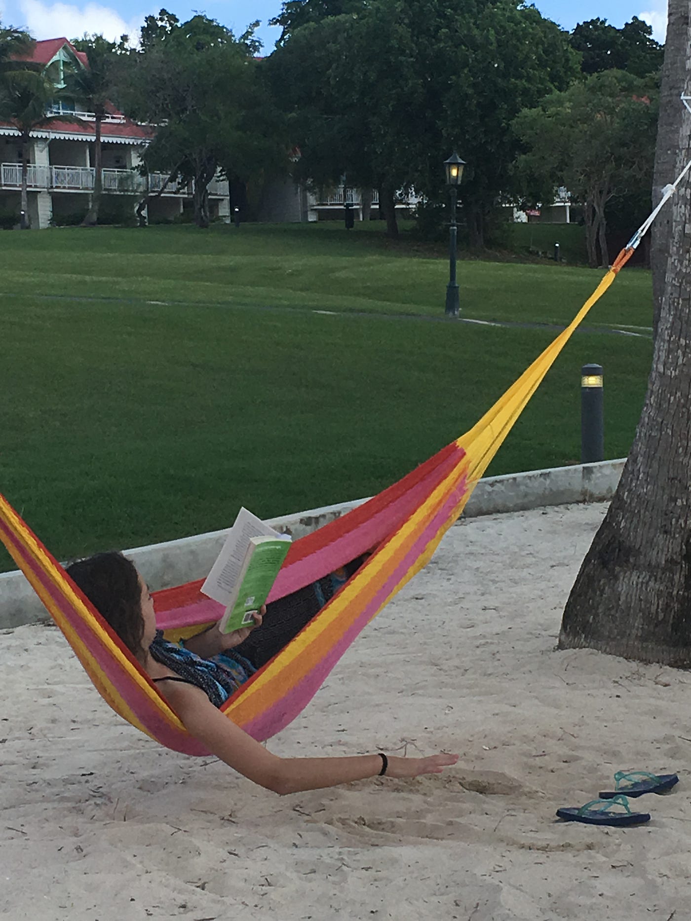 Daughter chillin’ on the beach reading a book