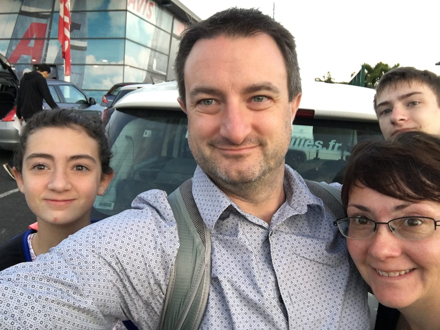 Family selfie with the (barely visible) rental car — we named her Marguerite