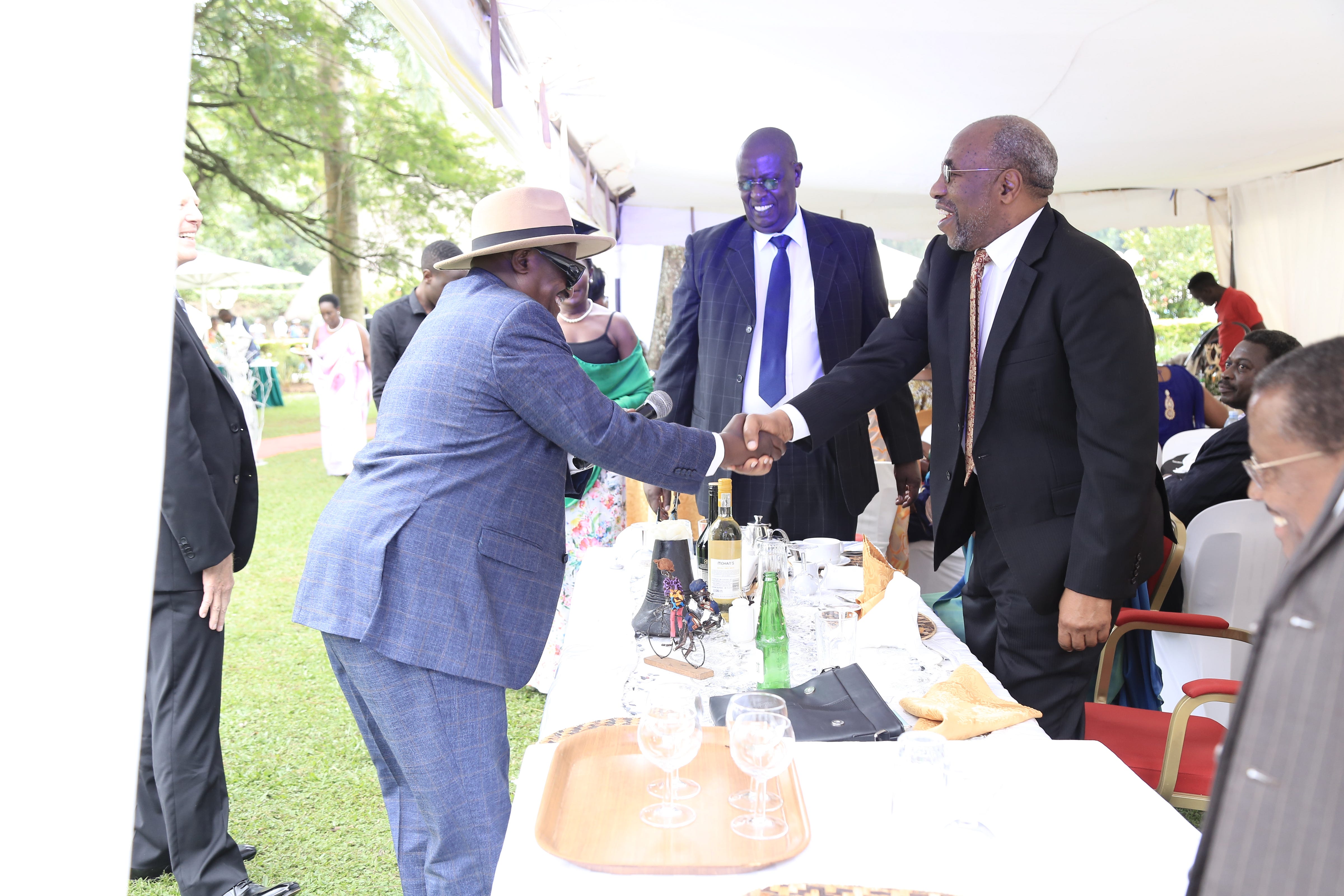 The man in the hat on the left is Frank, and he represented the groom’s family in the negotiations. The man on the right represents the bride. The gentleman in the tie standing behind them both is the bride’s father, Dr. Paul Kagwa.